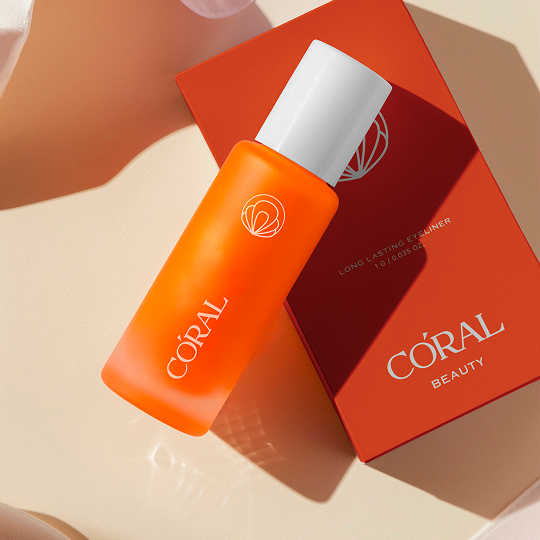 Coral Beauty Long Lasting Eyeliner — vibrant coral bottle resting on its red carton